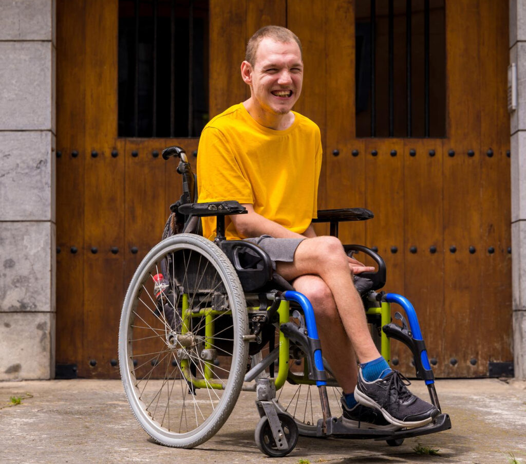 Smiling man in a wheelchair outdoors