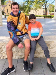 Two brothers smiling together on a community outing